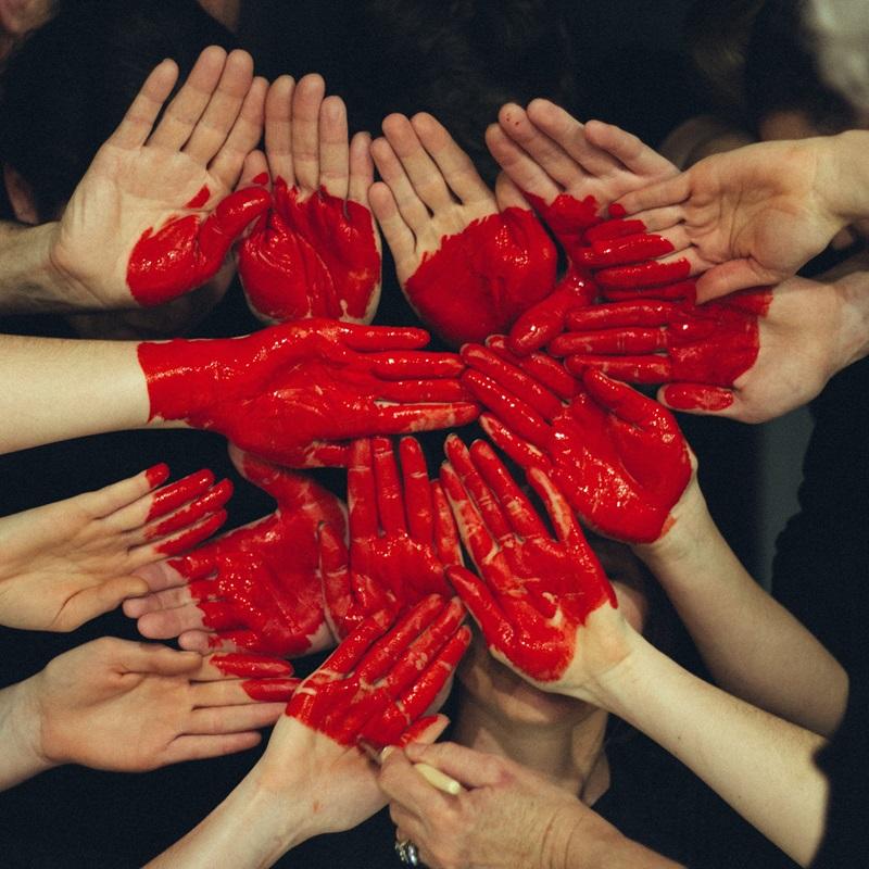 Heart painted on hands. Photo by Tim Marshall on Unsplash
